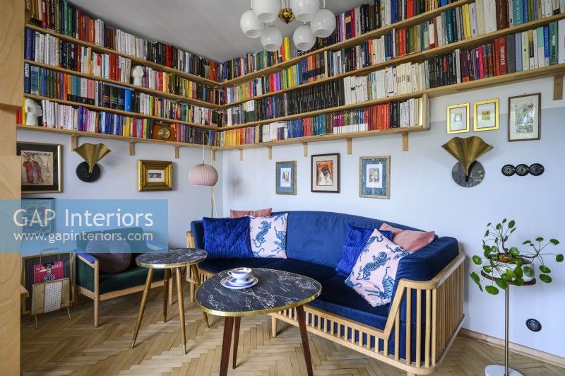Living room with a blue sofa and a collection of books