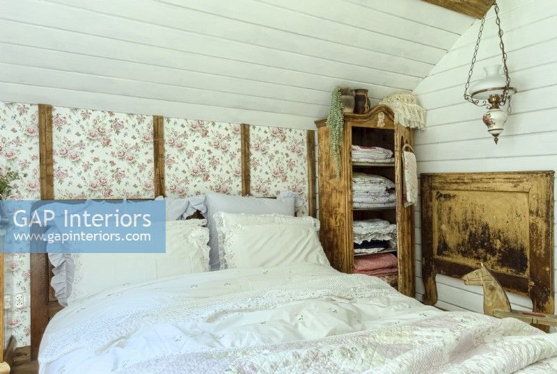 Bed in a country bedroom in the attic