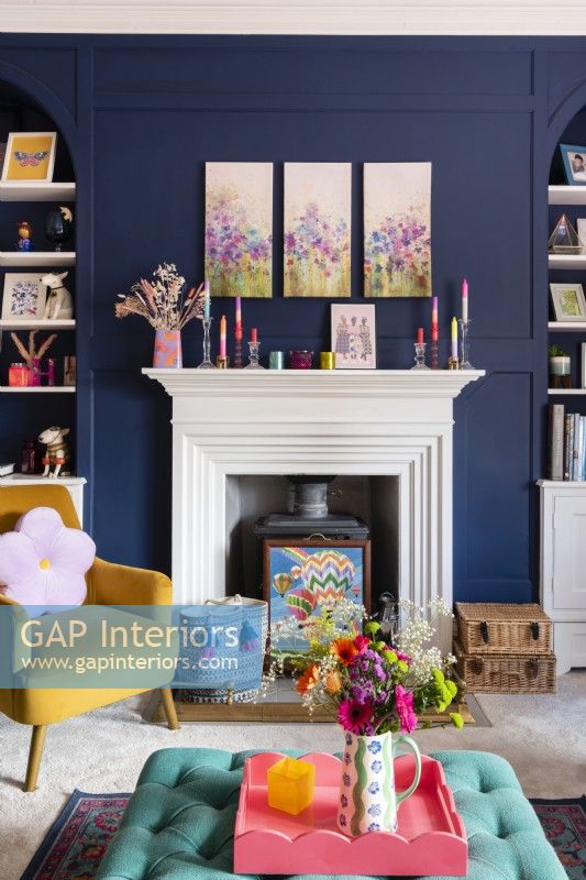 White fireplace and mantlepiece with blue panelled walls