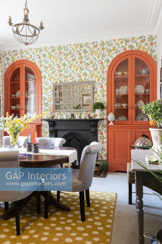 Colourful dining room with built in alcove arched cupboards