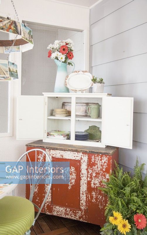 Vintage sideboard in dining area of 3-season porch makeover
