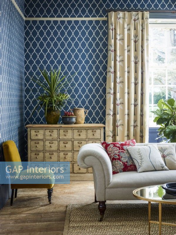 Living room with blue patterned wallpaper