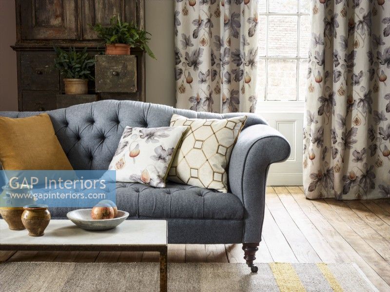 Living room with grey sofa and fig design curtains