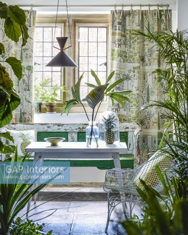 Period conservatory with house plants, bench and table