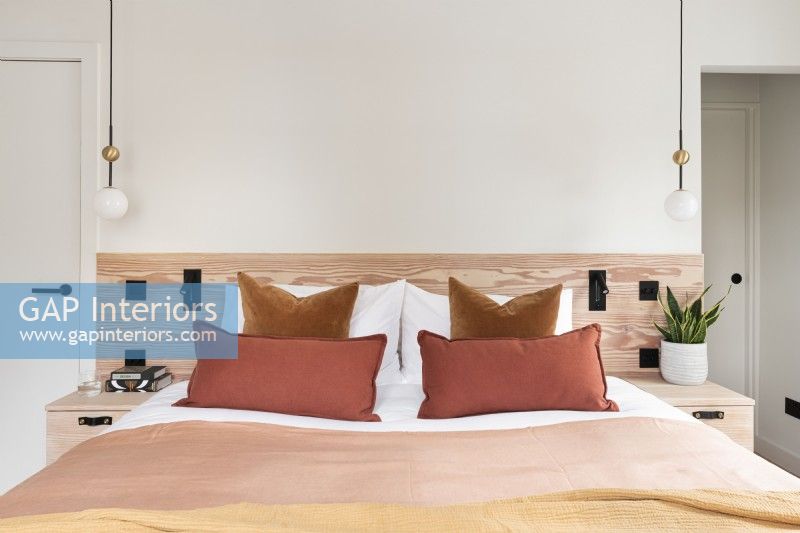 Contemporary bedroom with wooden headboard.