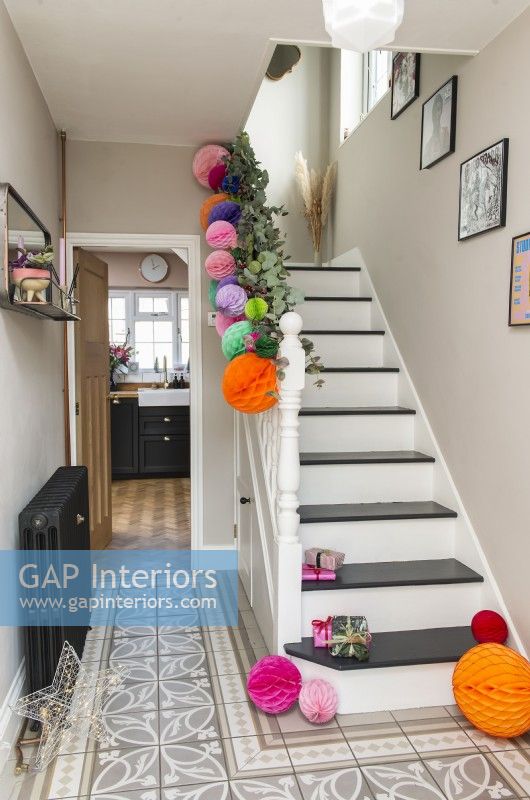 Garland and colourful paper baubles in modern hallway