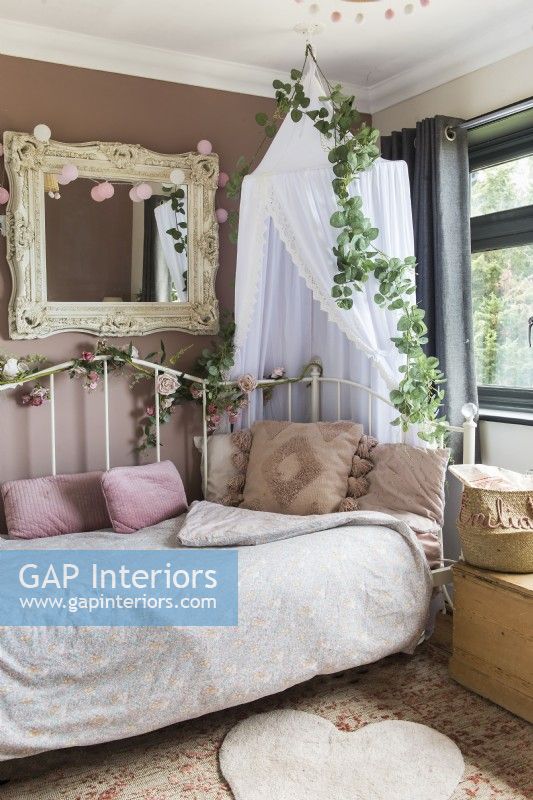 Daybed and canopy in feminine bedroom