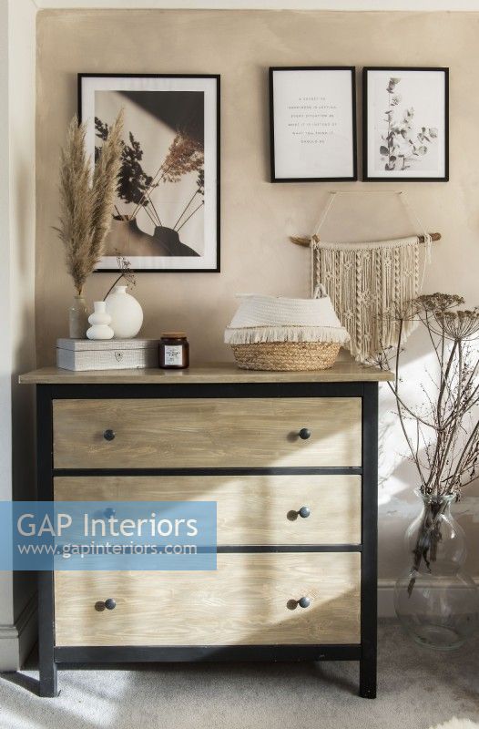 Black and stripped wooden chest of drawers 