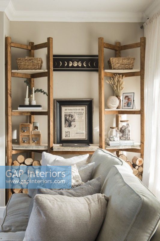 Wooden shelving unit in modern neutrally decorated living room