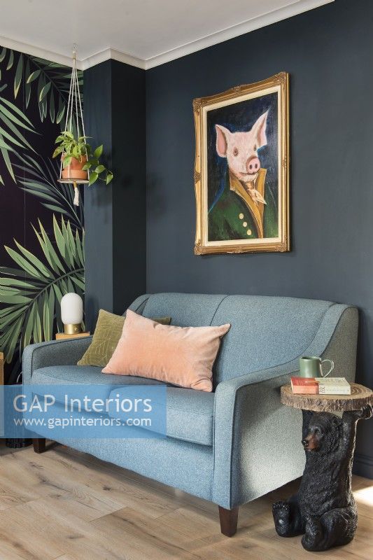 Quirky pig portrait painting above sofa in colourful living room