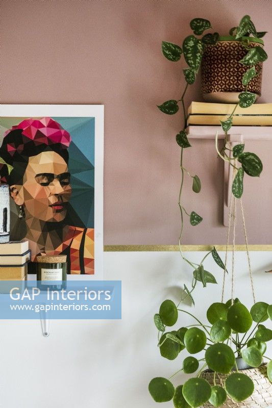 Detail of houseplants and painting of Frida Kahlo 