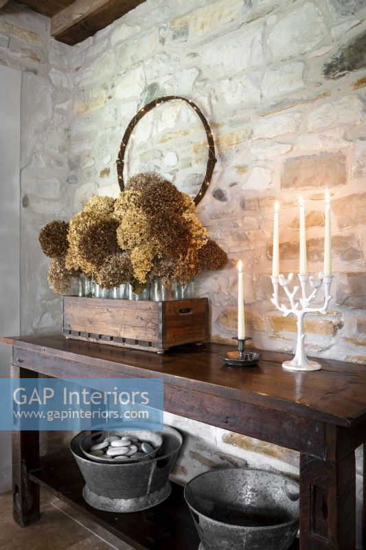 Dried flower display and sideboard in country dining room