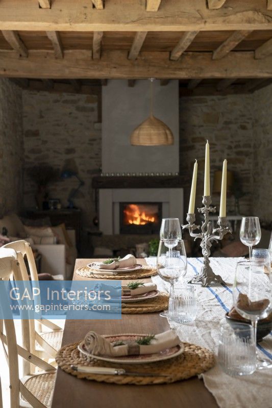 Lit fire place in country dining room