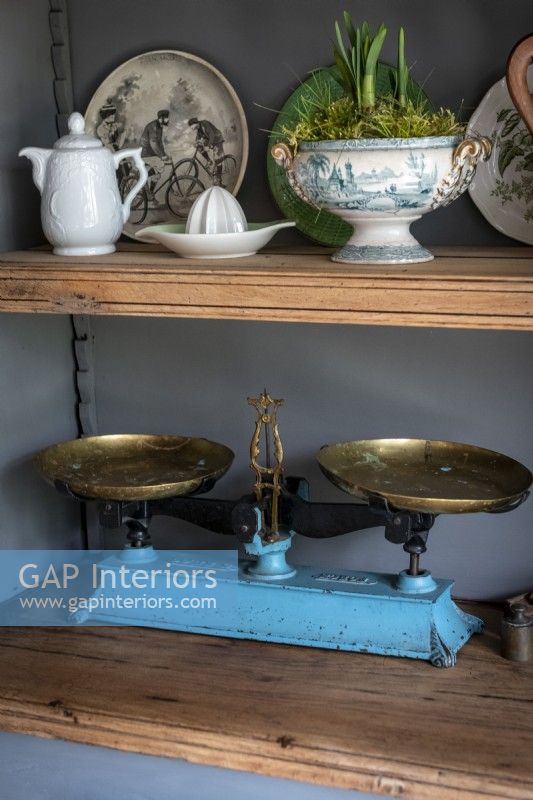 Vintage weighing scales on wooden dresser shelves - detail 