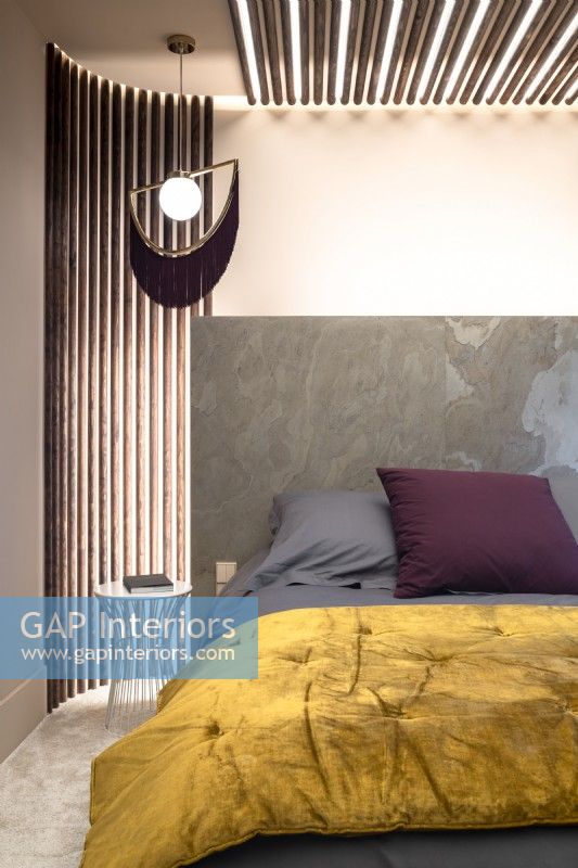 Marble headboard and contemporary lighting in modern bedroom