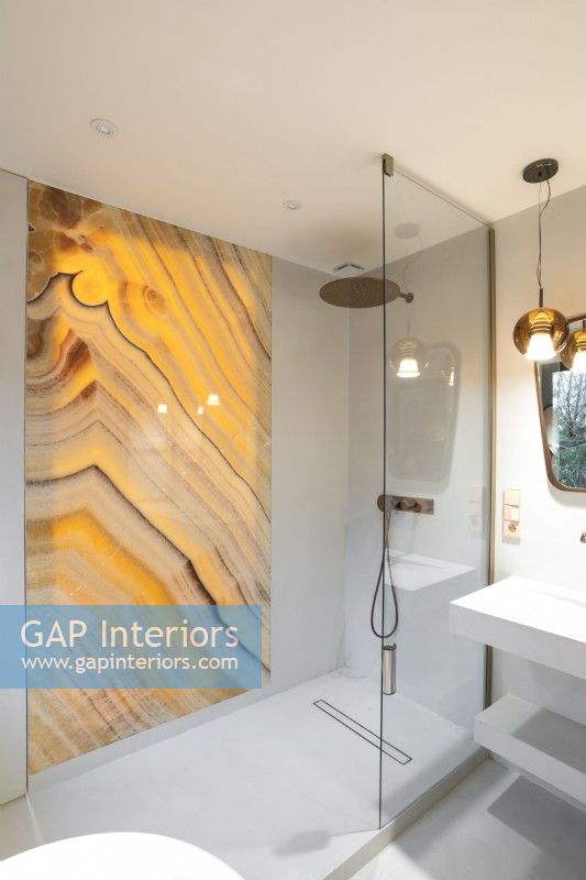 Decorative marbled glass panel in contemporary shower cubicle