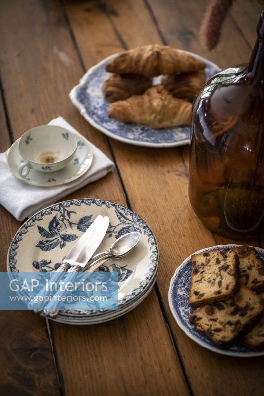Coffee cup and cakes on dining room table - detail