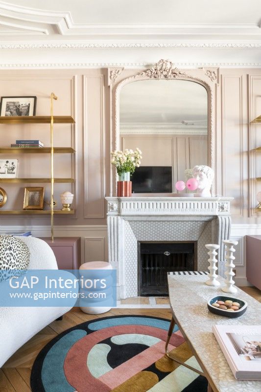 Modern furniture in pink painted living room with period features