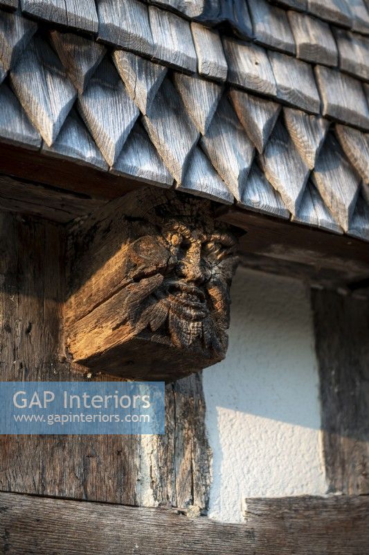 Detail of carved wooden gargoyle on 16th Century manor house 