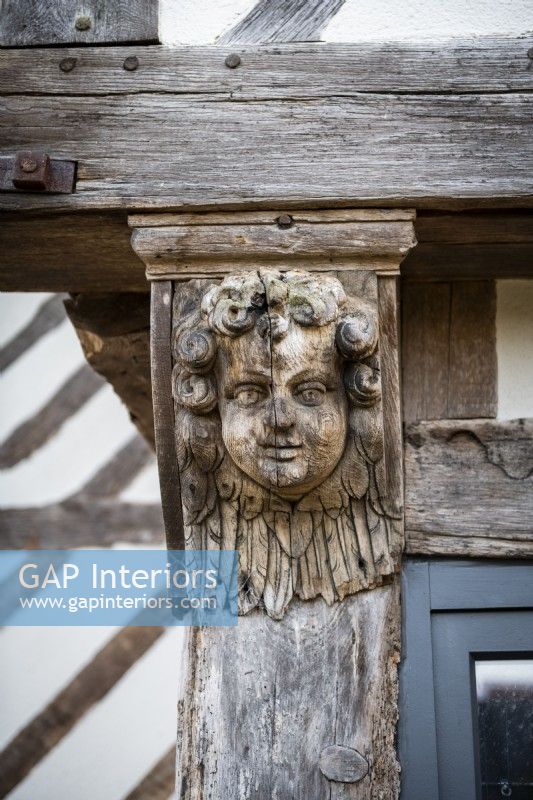 Carved wooden face on exterior of 16th Century manor house - detail