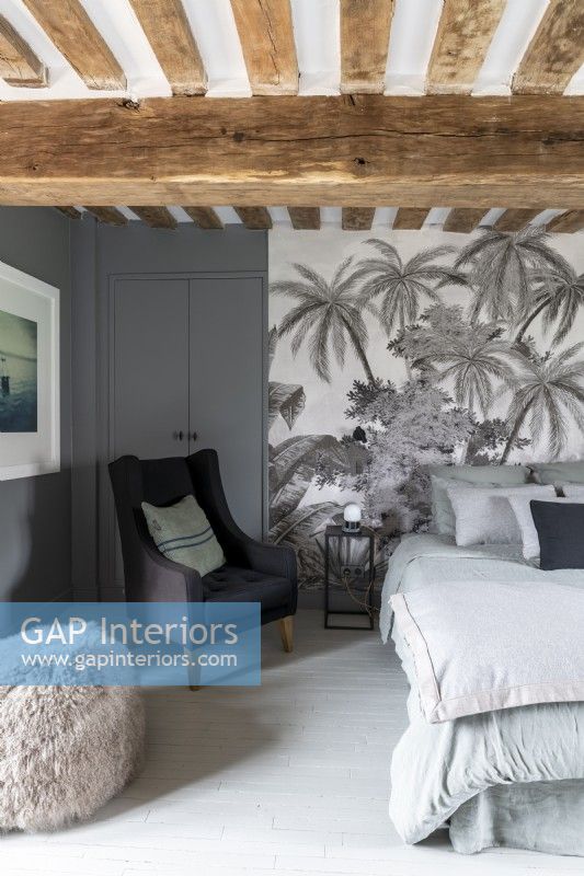 Grey bedroom with tropical scene feature wall