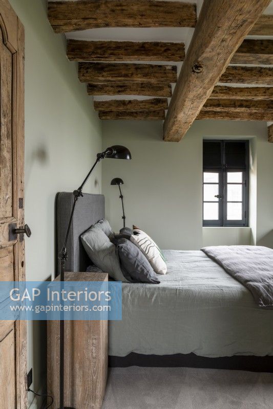Modern country bedroom with pale green painted walls