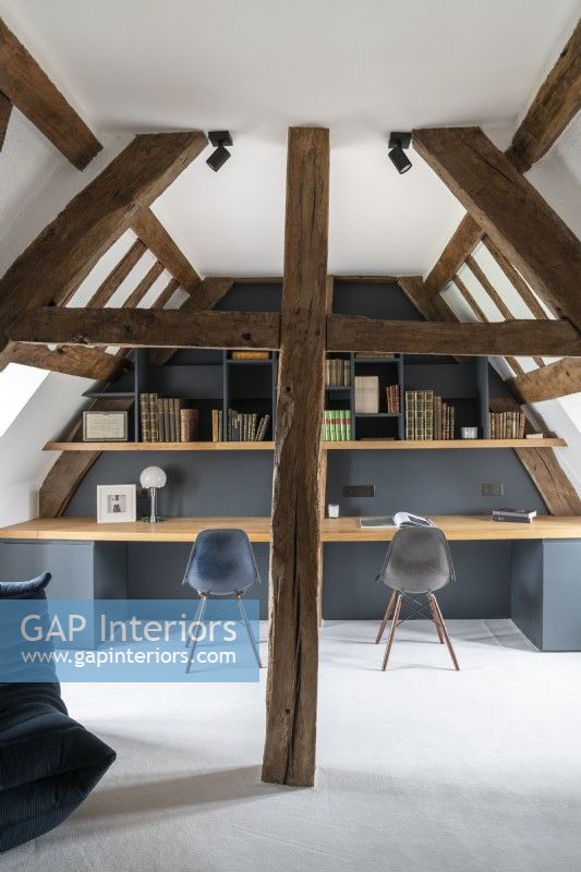 Modern built-in double desk in loft space with vaulted ceiling