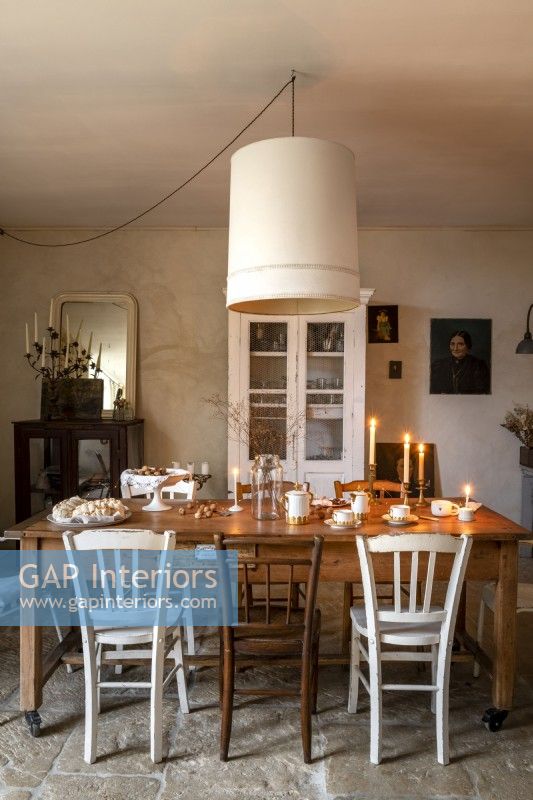 Lit candles on table in country dining room
