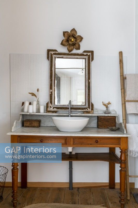 Vintage vanity unit with sink in country bathroom