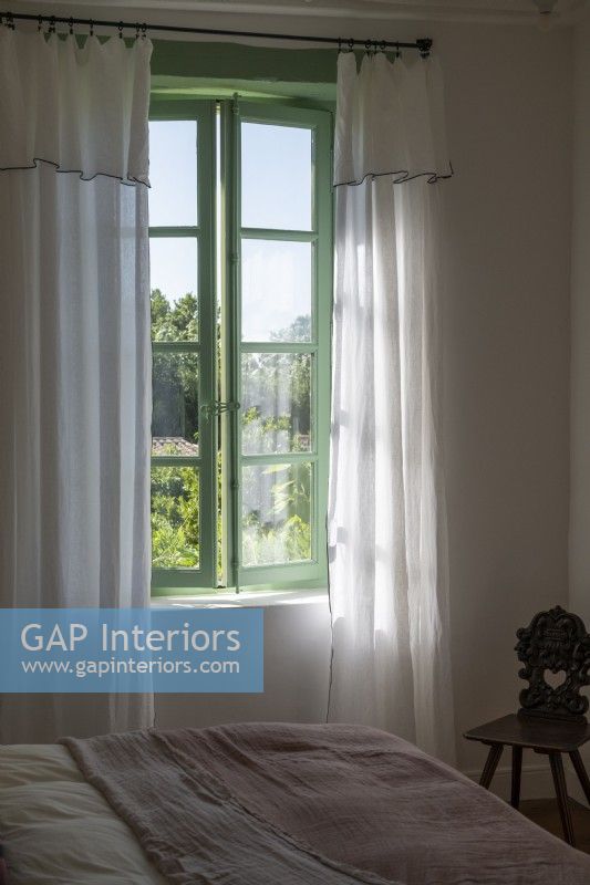 View of open windows and thin linen curtains