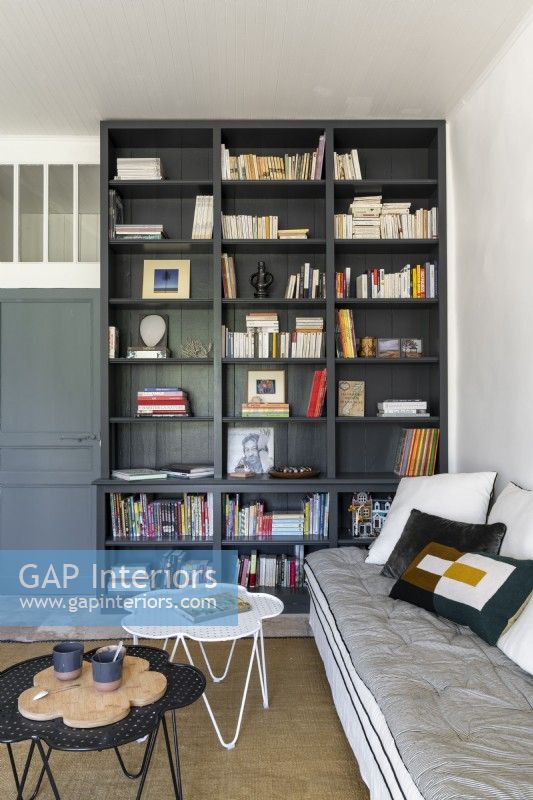 Black bookshelf unit in modern living room