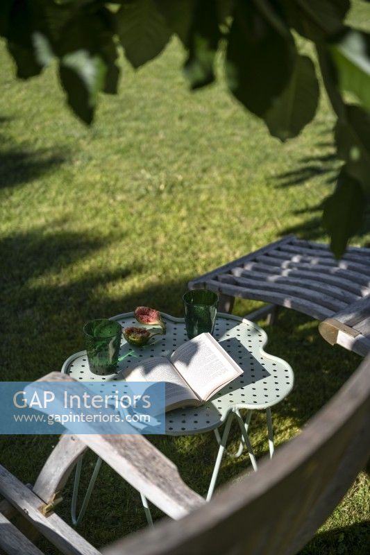 Book on small table in garden - detail 