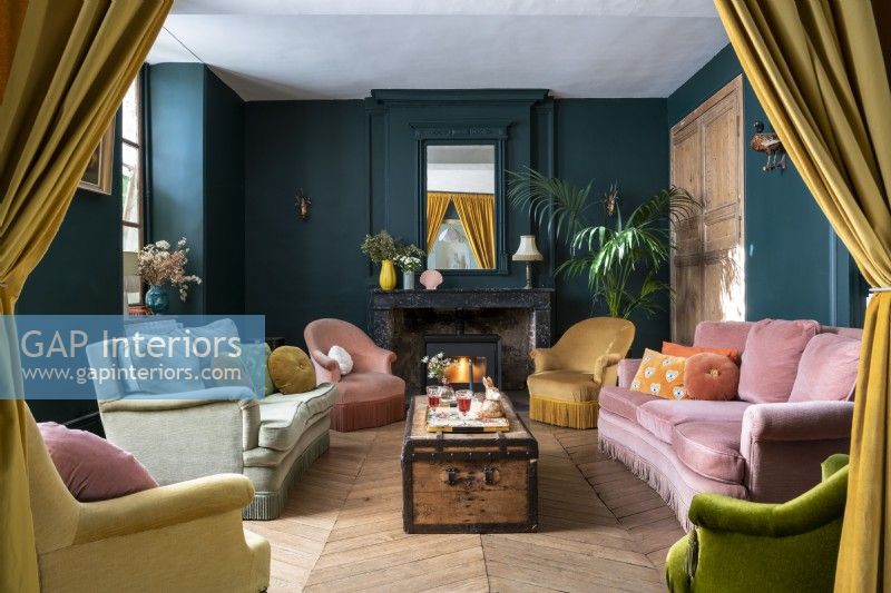 Colourful classic style living room with lit wood burning stove