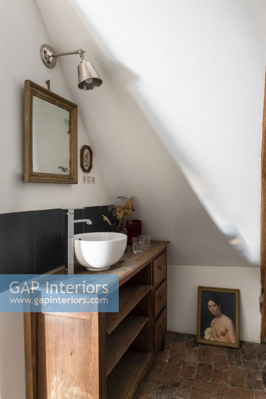 Wooden unit with small sink in country bathroom
