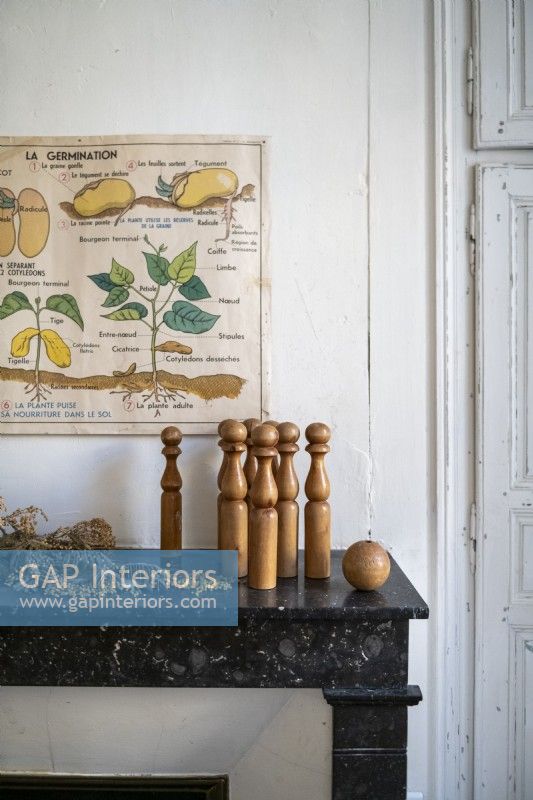 Wooden vintage bowling pins and ball on mantelpiece - detail
