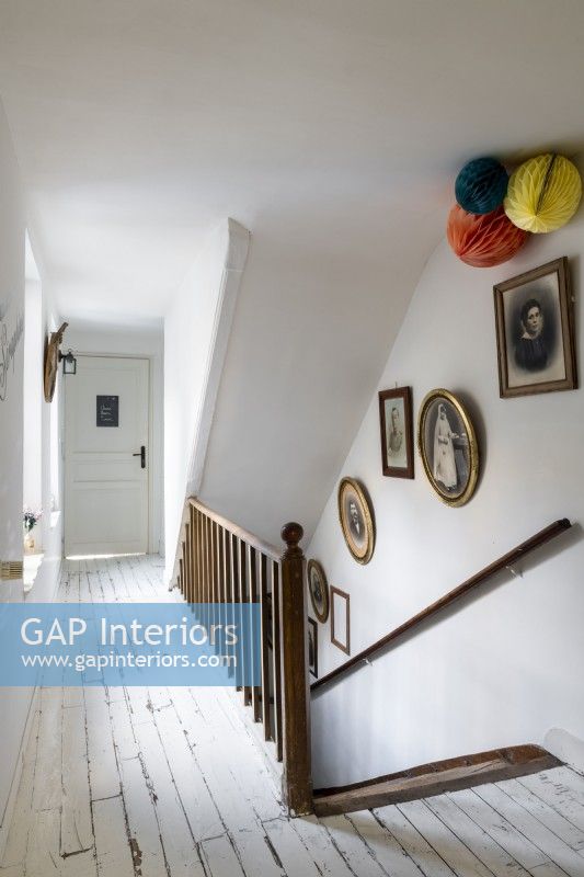 White painted hallway with view of wooden staircase 