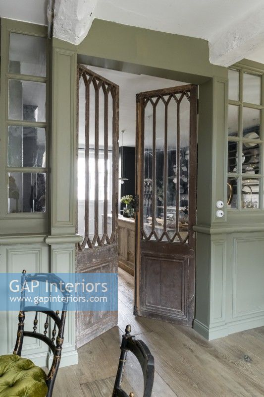 Distressed wooden internal double doors in classic dining room