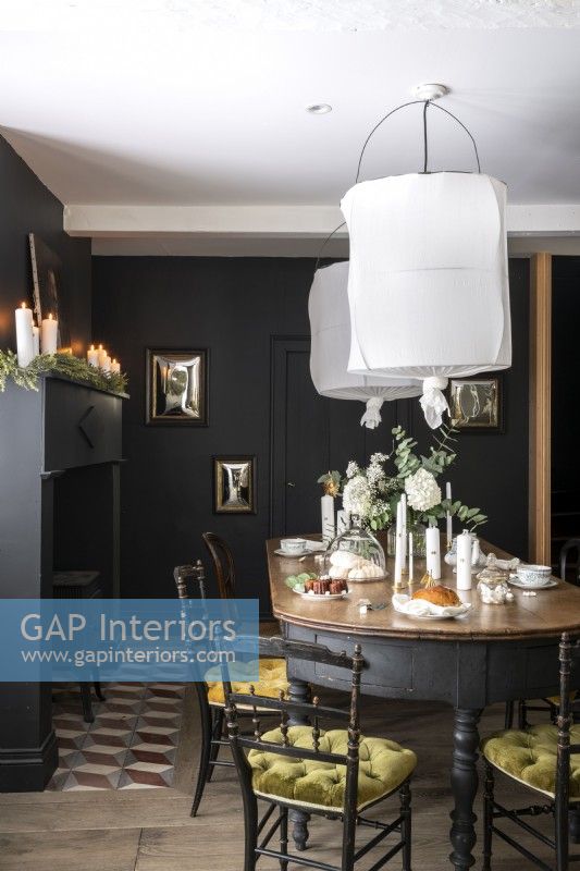 Dark grey painted classic style dining room with white accessories 