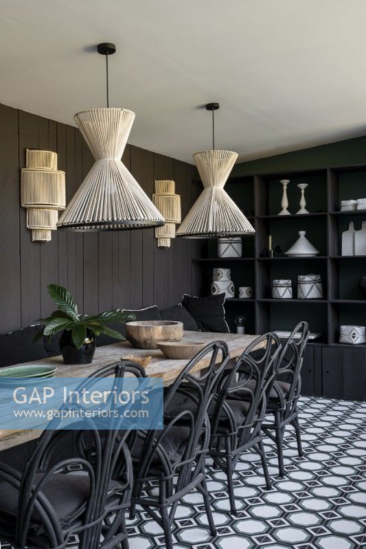 Black wicker chairs in modern dining room