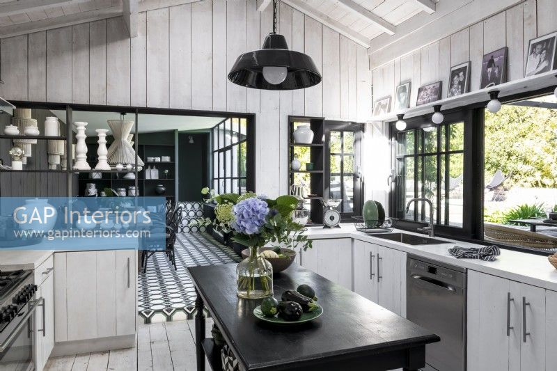 Black and white modern country kitchen with view to dining room