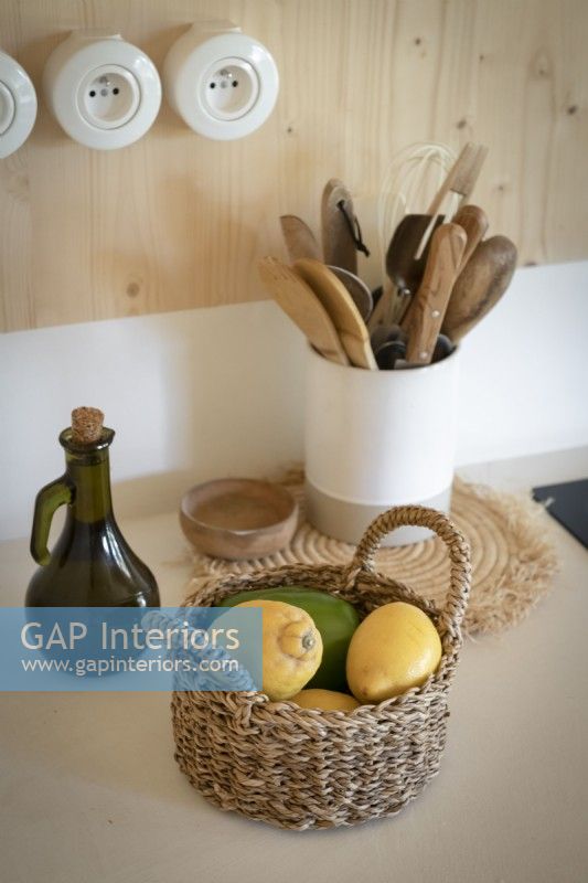 Detail of country kitchen worktop with basket of fruit