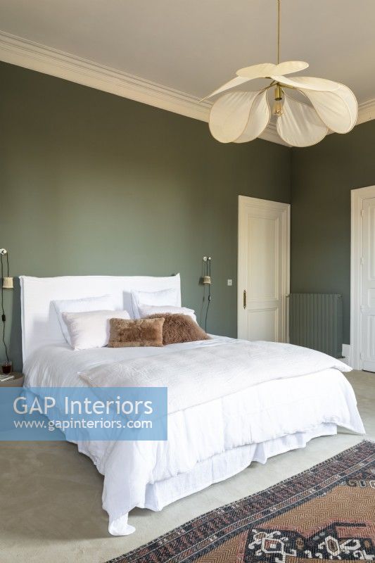 Classic style bedroom with green painted walls and white bedding