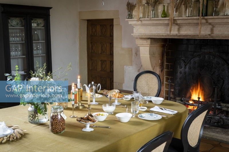 Table laid for breakfast with lit fire