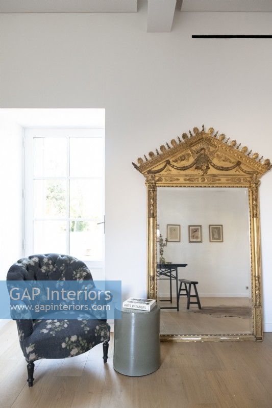 Large ornate gilded mirror and armchair