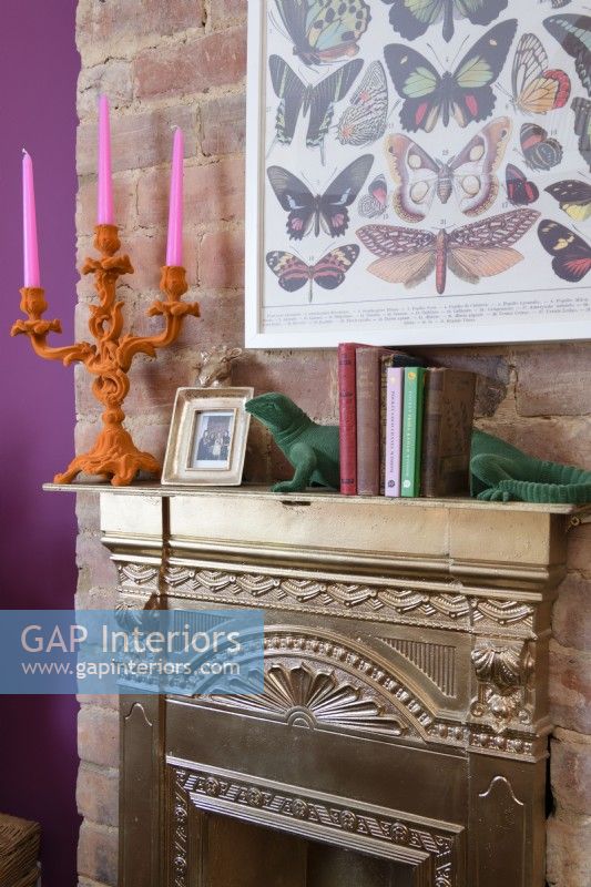 Gold painted Victorian reclaimed fireplace against an exposed brick chimney breast