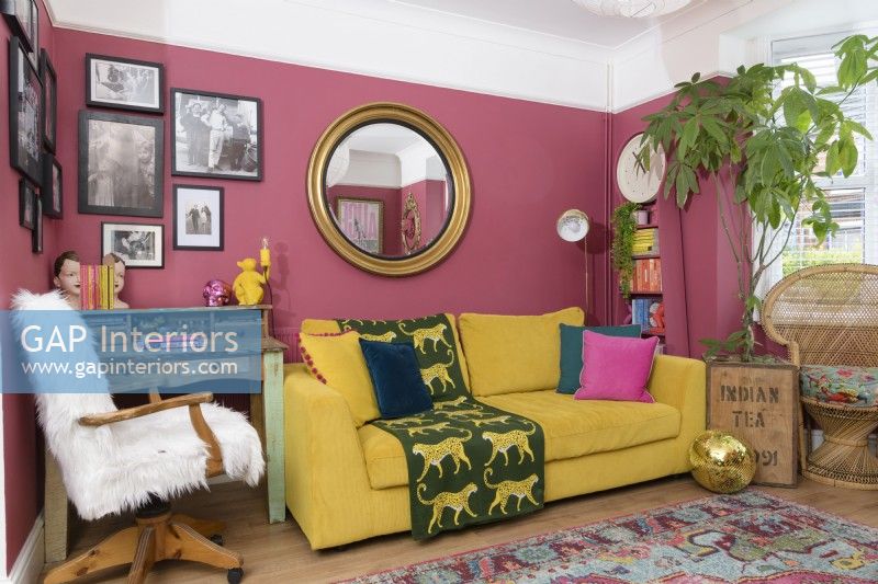 Yellow sofa in a pink living room