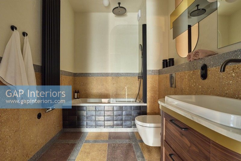 Brown bathroom with stone floor and walls