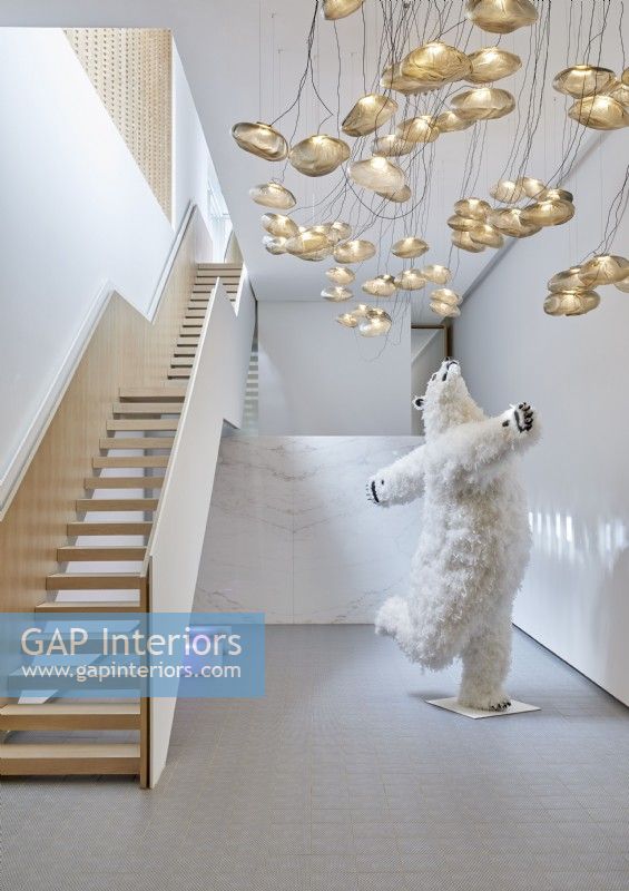 Quirky polar bear sculpture in white contemporary hallway