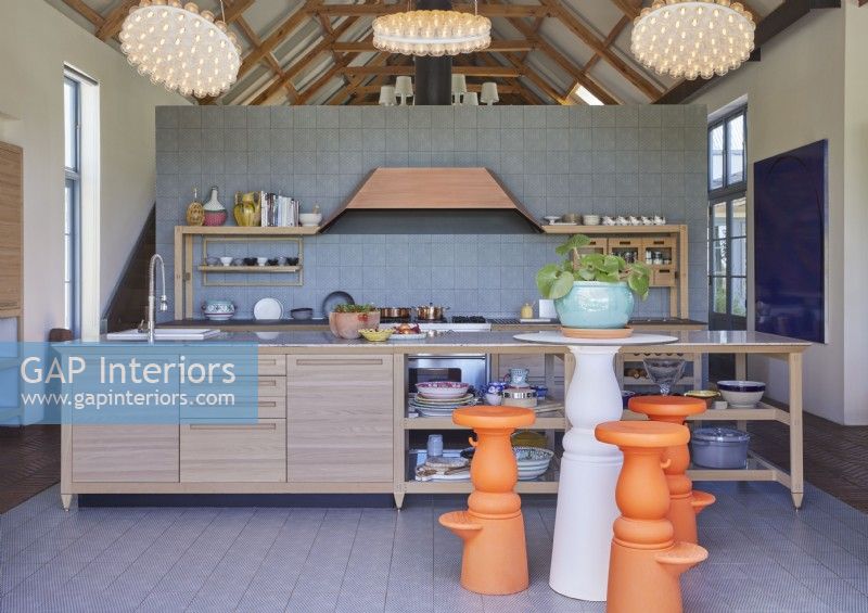 Unusual bright orange barstools in contemporary kitchen
