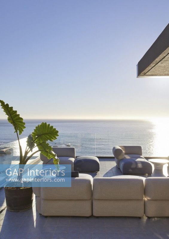 Sofas on terrace in large outdoor living area with sea views